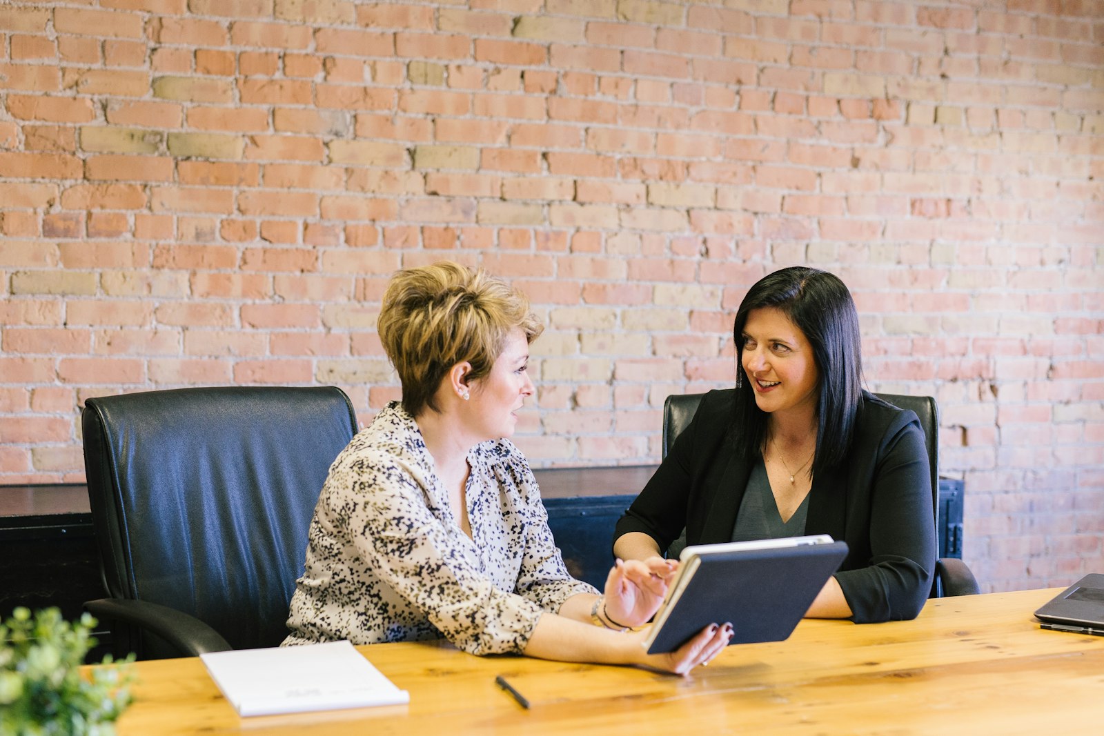 Two compliance professionals reviewing a case together