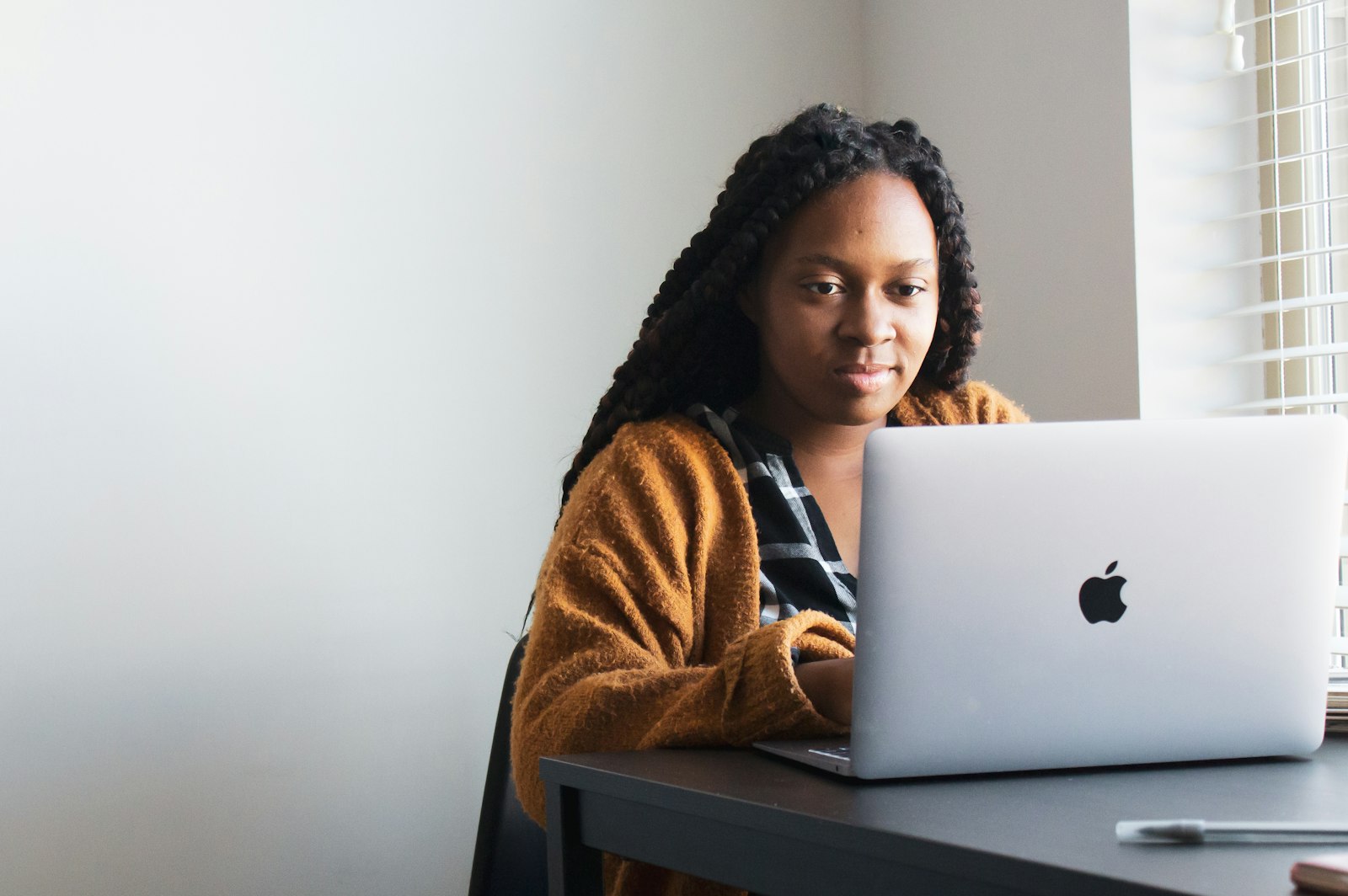 A professional studying for a certification on a laptop